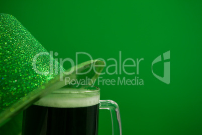 St Patricks Day leprechaun hat with mug of green beer