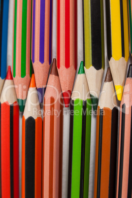 Colored pencils arranged in interlock pattern on white background