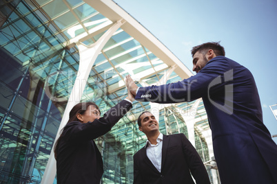 Businesses executives giving high five to each other