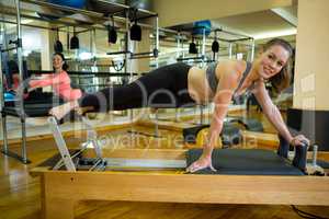 Portrait of happy women practicing stretching exercise