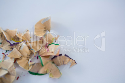 Colored pencils shavings on a white background