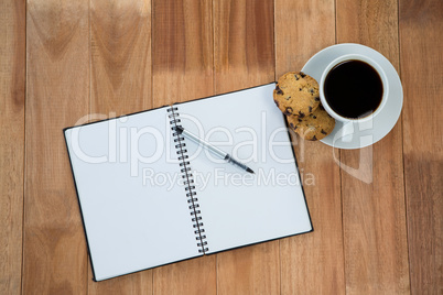 Open diary with pen and black coffee