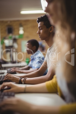Schoolboy studying in computer classroom