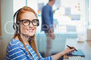 Female graphic designer working with headphones