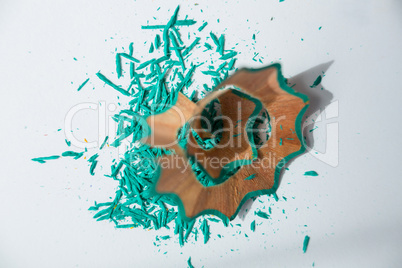 Green color pencils shavings on a white background