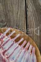 Beef ribs rack on wooden tray against wooden background