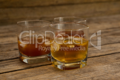 Three glasses of whiskey with ice cube