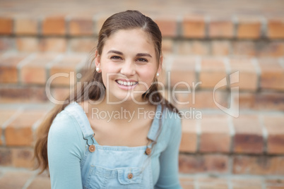 Portrait of happy schoolgirl sitting on staircase