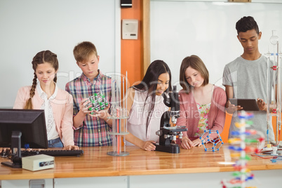 Group of students experimenting molecule model in laboratory