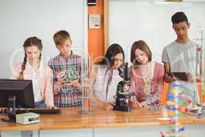 Group of students experimenting molecule model in laboratory