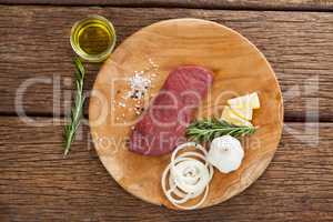 Beef steak and ingredients on wooden board