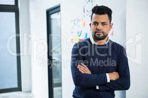 Graphic designer standing with hands crossed in creative office