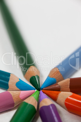 Close-up of colored pencils arranged in a circle