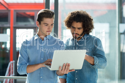 Two business executives working on laptop