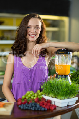 Smiling shop assistant standing at counter