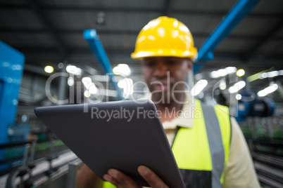 Factory worker using digital tablet in the factory