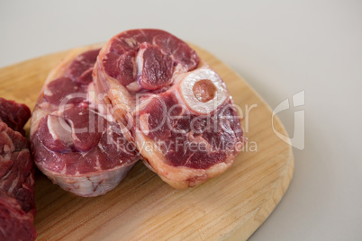Sirloin chop and beef steak on wooden tray