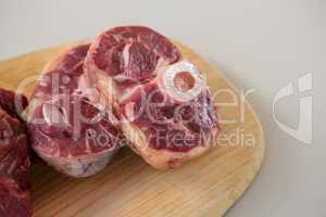 Sirloin chop and beef steak on wooden tray