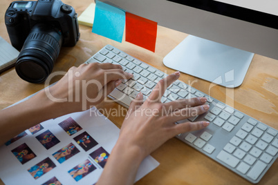 Hand of female graphic designer typing on keyboard