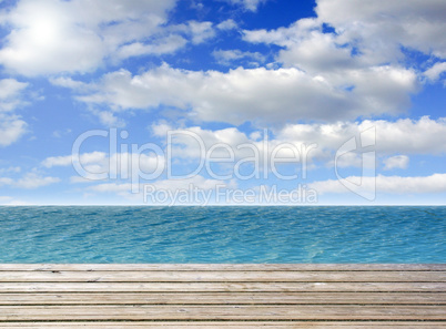 Wooden plank with turquoise sea or ocean and blue sky