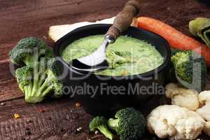 Broccoli cream soup and ingredients on table