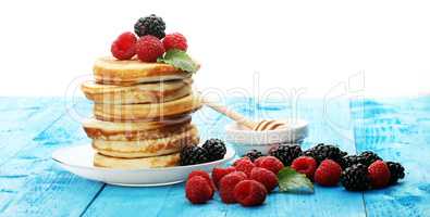 Pancakes with berries and maple syrup