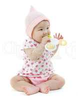 Asian baby girl biting on teething toy