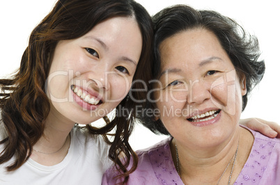 Senior mother and adult daughter close up face