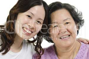 Senior mother and adult daughter close up face