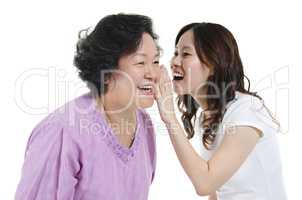 Mother and daughter telling secret