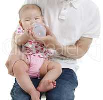 Daddy feeding water to baby