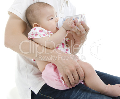 Daddy bottle feeding to baby