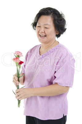 Senior woman and carnation flower on mothers day
