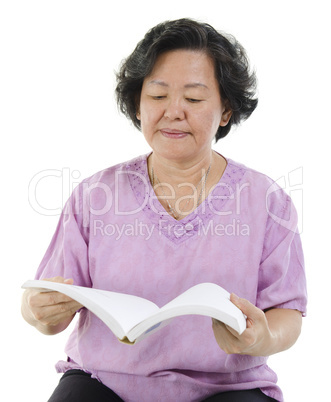 Senior adult woman reading book