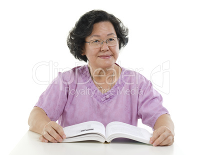 Portrait of Senior adult woman reading book