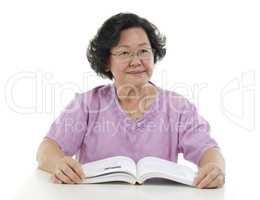 Portrait of Senior adult woman reading book