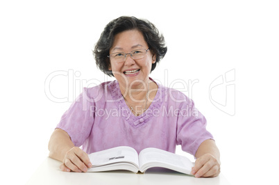 Wise Senior adult woman reading book