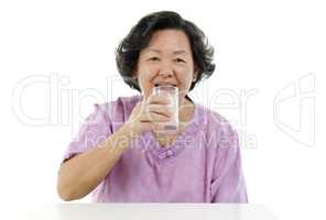 Senior adult woman drinking soy milk