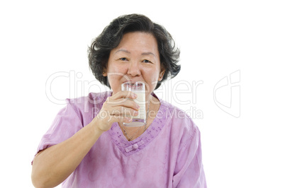 Senior woman drinking milk