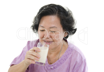 Senior woman drinking soy milk