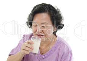 Senior woman drinking soy milk