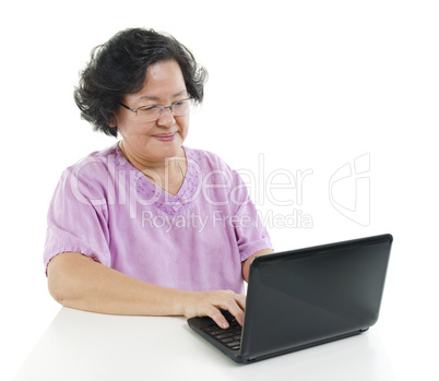 Senior adult woman using laptop computer