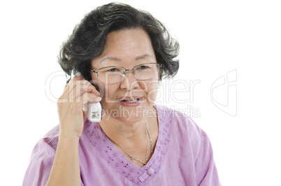 Senior adult woman calling on telephone