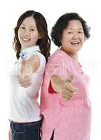Asian senior mother and adult daughter thumbs up
