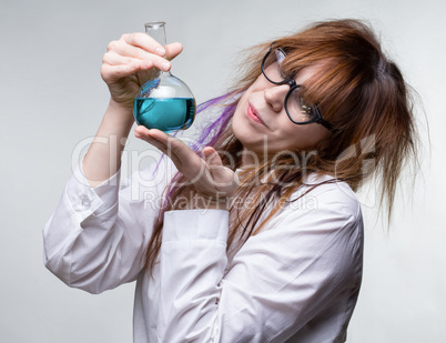 Scientist woman with blue liquid