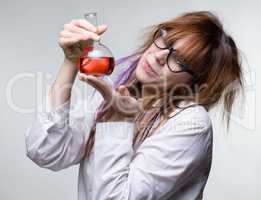 Scientist woman with red liquid