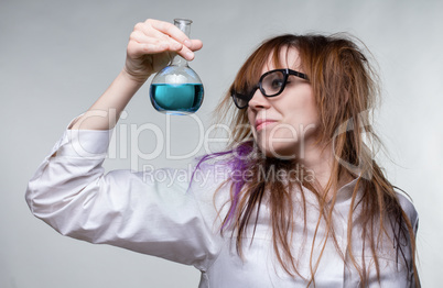 Scientist shaggy woman with blue liquid