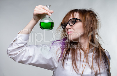 Scientist shaggy woman with green liquid