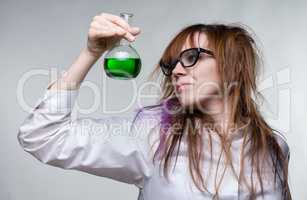 Scientist shaggy woman with green liquid