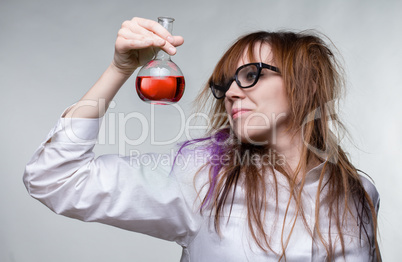 Scientist shaggy woman with red liquid